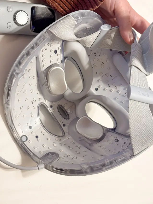 Inside the Shark CryoGlow mask, showing LED lights, eye surrounds, metallic under-eye cooling pads and adjustable straps.