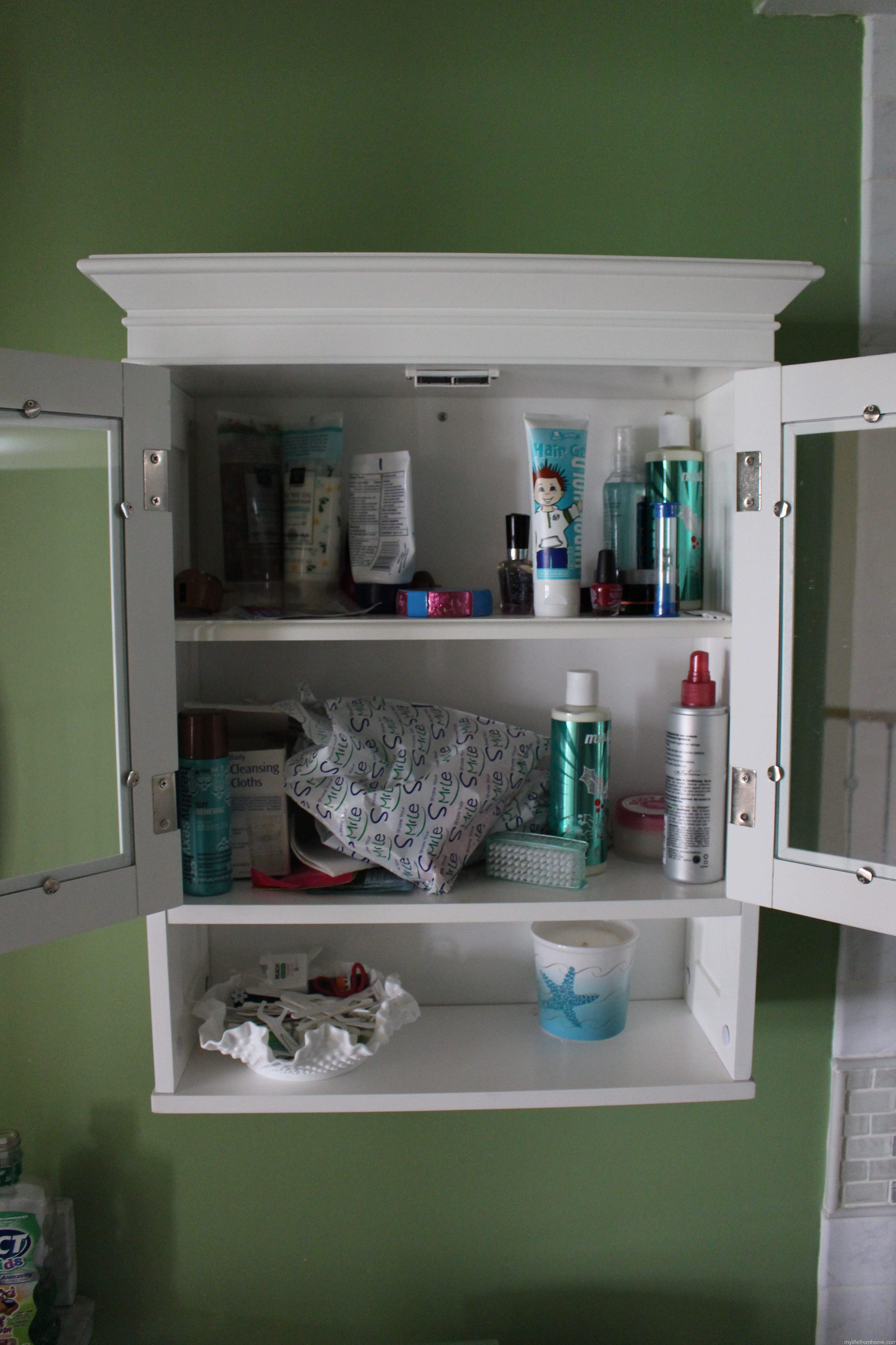 Overwhelmed Bath Cabinet by www.whitecottagehomeandliving.com