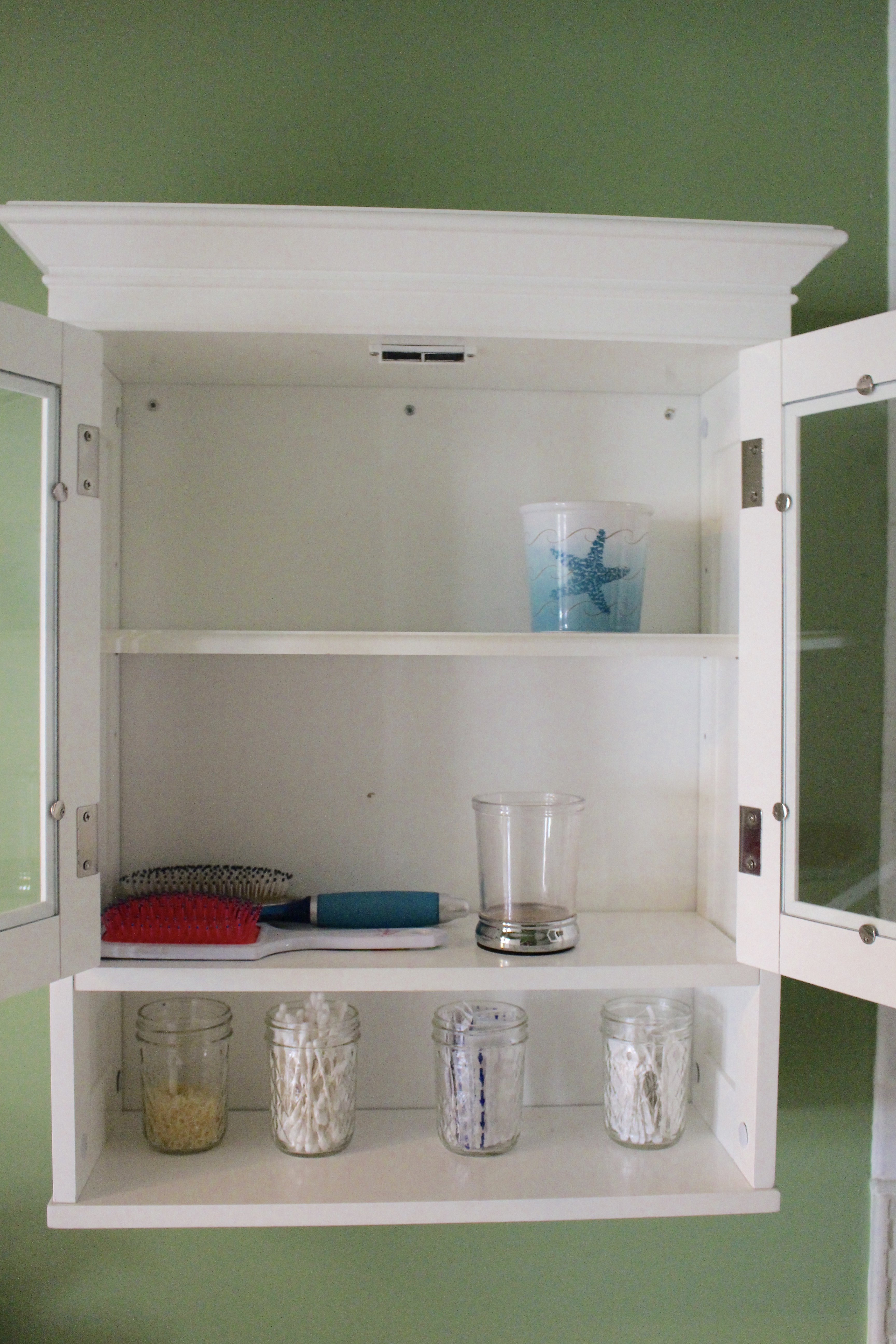 Cabinet Storage Ideas for a Small Bath by www.whitecottagehomeandliving.com
