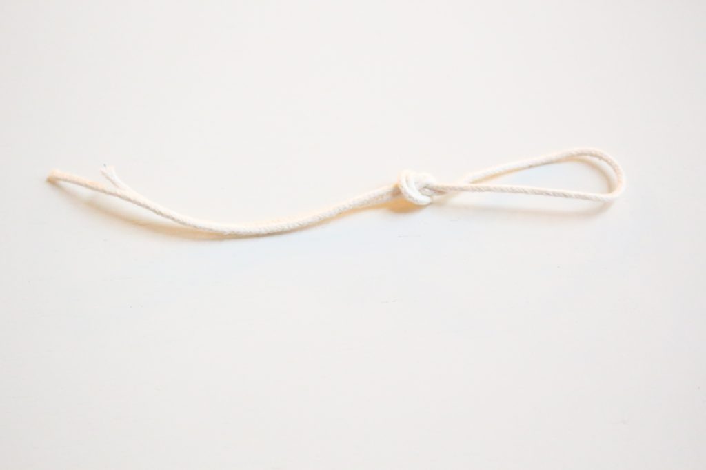 Tying a wick in a loop