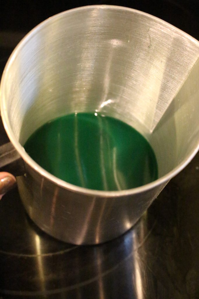 Melting wax flakes with a crayon in it to add some colour