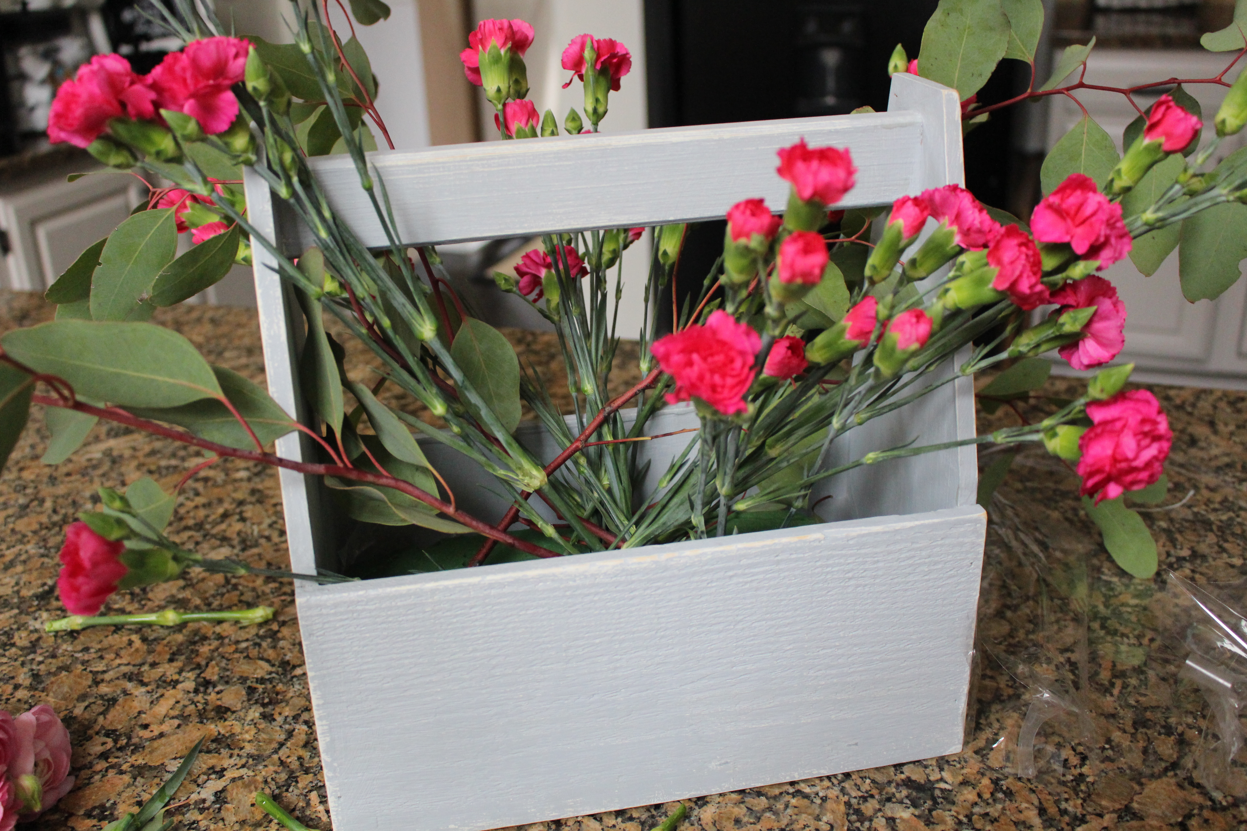 Toolbox Crate Flower Arrangement- spring flower- arranging flowers- how to arrange flowers- unusual flower vessels- arranging flowers- spring decor- flower boxes