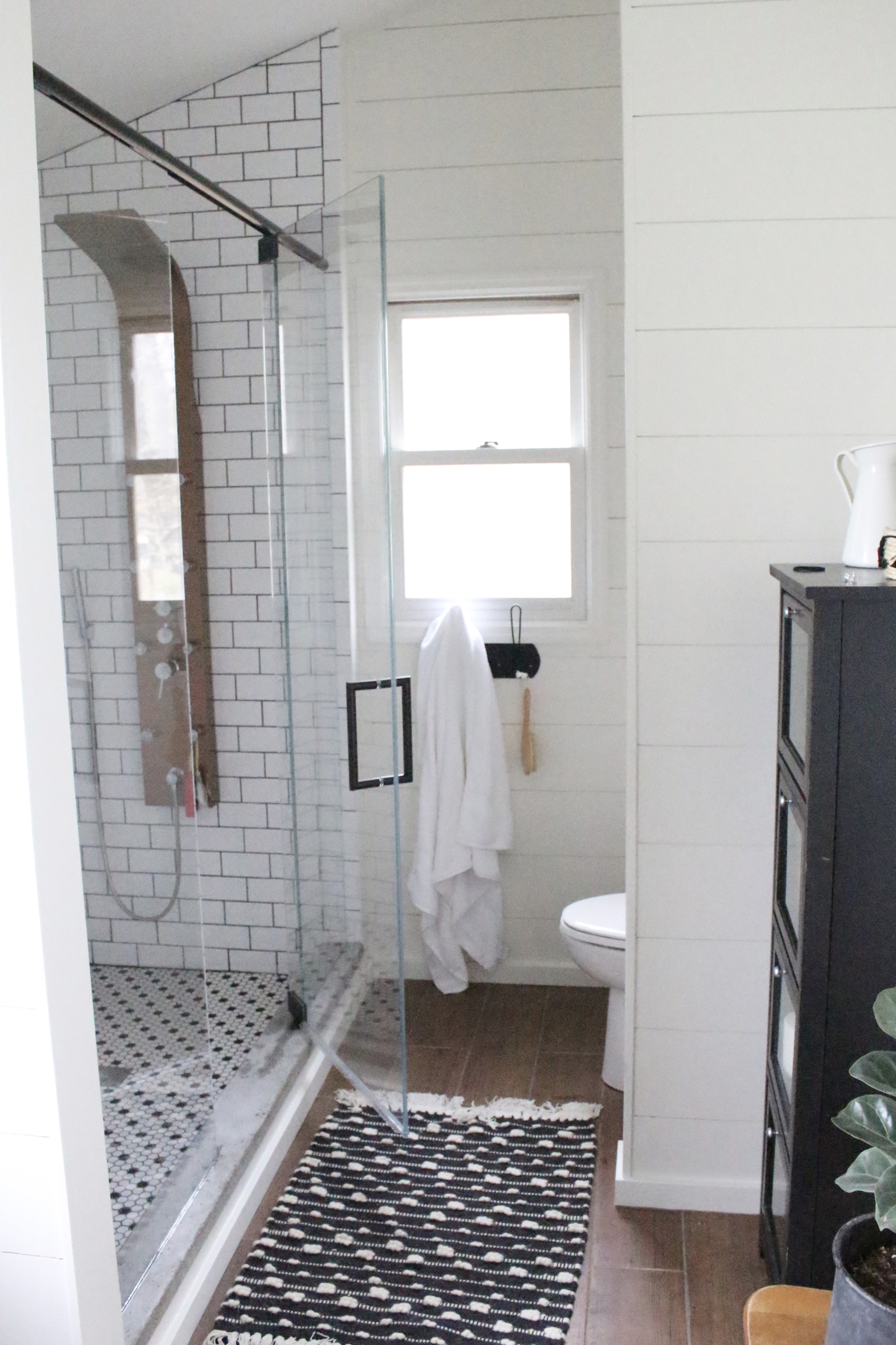 Shower glass- bathroom renovation- master bathroom- subway tile- spa shower- copper accents- farmhouse style bath