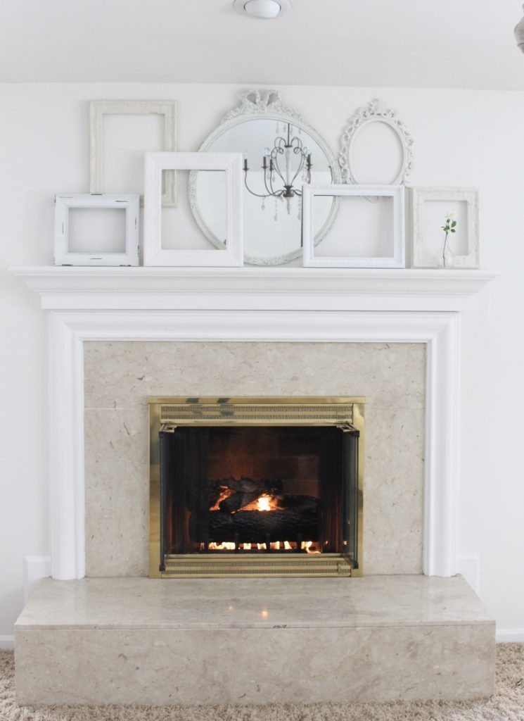 A shabby chic white mantel- layered frames- white mirror- all white decor- romantic design- fireplace decor- mantel decor- home design- decor ideas- mantles- french country style mantel- DIY- Do it Yourself- DIY projects- room design- wall decorating ideas- gallery wall- room decor ideas- decoration ideas