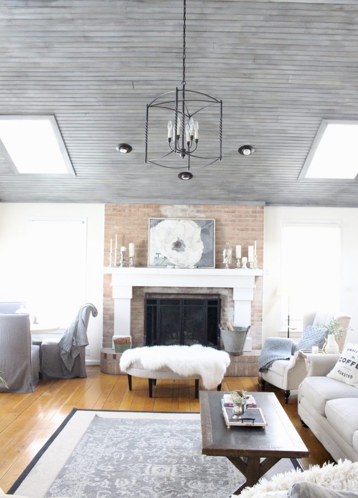 Gray and White Cottage Living Space- farmhouse style room- decor- DIY- weathered wood ceiling treatment- painted ceiling- paint and stain treatment on pine- how to- paint- stain- wood- ceiling- winter decor- room design- home decor- living room decorating ideas- rustic home decor- wall decorating ideas- decoration ideas- room decor ideas- mantel ideas- french county style decor-tv room- lantern chandelier