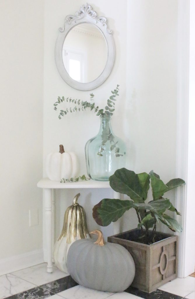 A fall vignette in the entryway- seasonal decor- fall decorating- wooden pumpkins- autumn decor- decorating an entry- home design- fiddle leaf fig