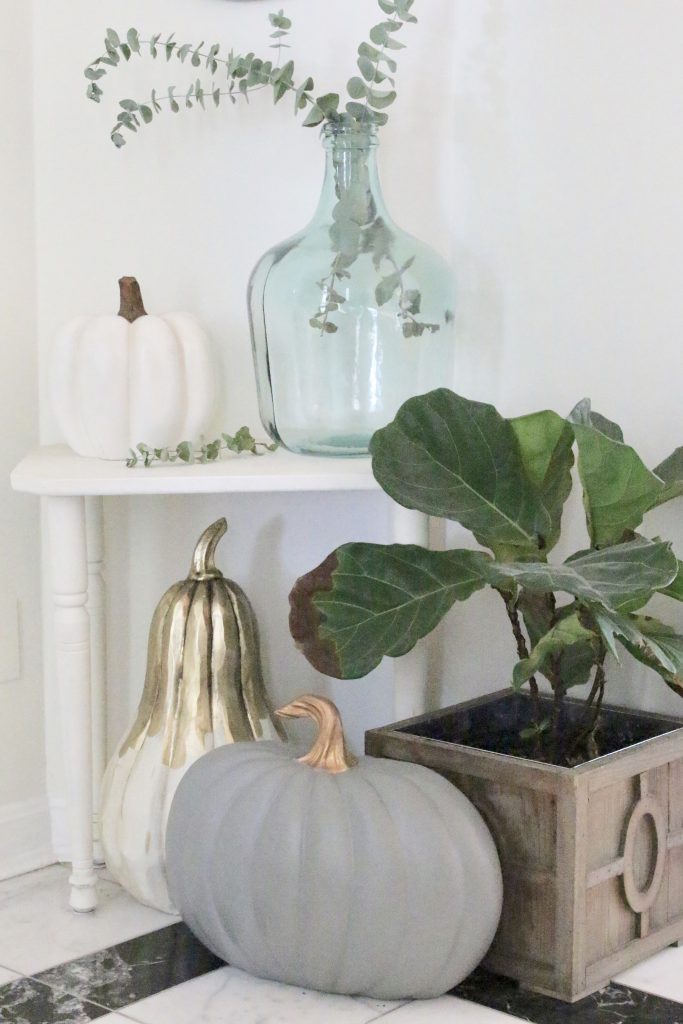 A fall vignette in the entryway- seasonal decor- fall decorating- wooden pumpkins- autumn decor- decorating an entry- home design- fiddle leaf fig- small corner decor- decorating small spaces
