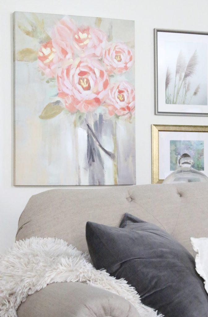 A new gallery wall in our family room- pastels- paintings- gallery wall- arrangement- wall decor- artwork- pale colors- neutrals- updated wall art- Home Goods- vintage- flower- art