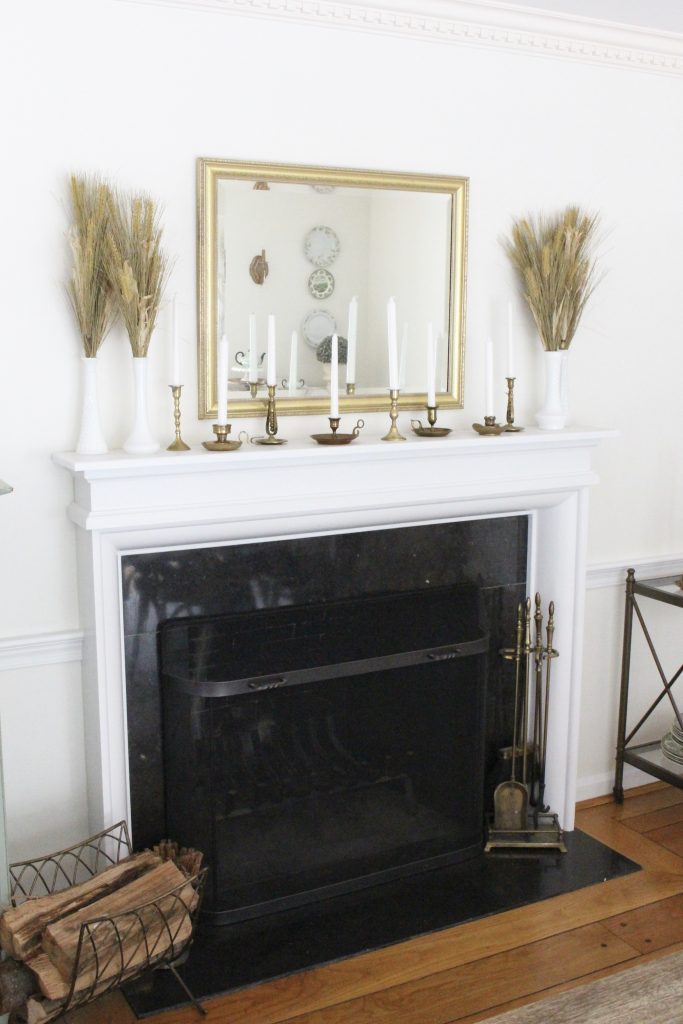 Simple neutral fall colors in our dining room- dining room- fall decor- neutral- living spaces- gold- brass- candlesticks-milk glass- fireplace decor mantel- decorating for fall- seasonal- fall mantel- tablescape