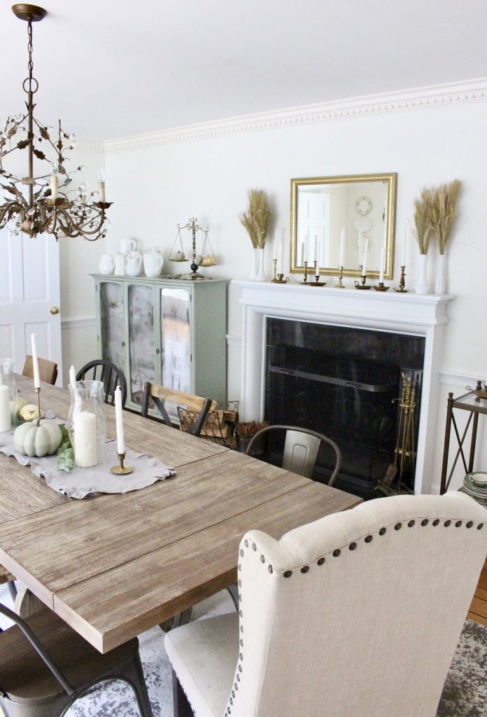 Simple neutral fall colors in our dining room- dining room- fall decor- neutral- living spaces- gold- brass- candlesticks-milk glass- fireplace decor mantel- decorating for fall- seasonal- table- painted cabinet