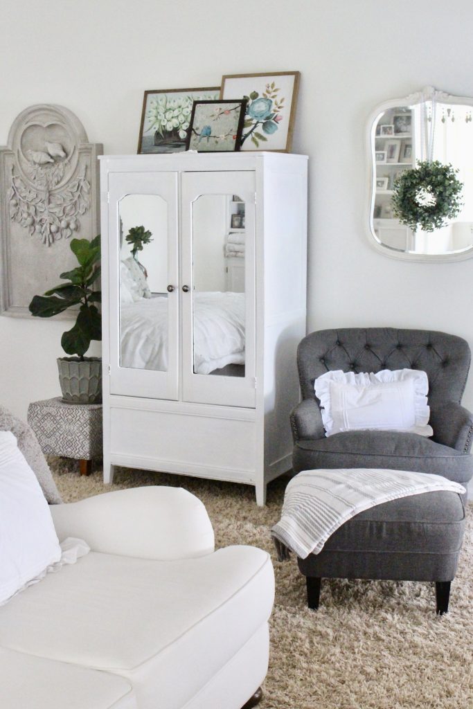 White Cottage Master Bedroom- gray- white- green- shabby chic bedroom- farmhouse decor- layered mirrors- painted gray furniture- DecoArt- Repose Gray- white bedding- white painted furniture- Armoire- fireplace in the bedroom- home design- large bedroom space- sitting area in the bedroom- bookshelves in a bedroom