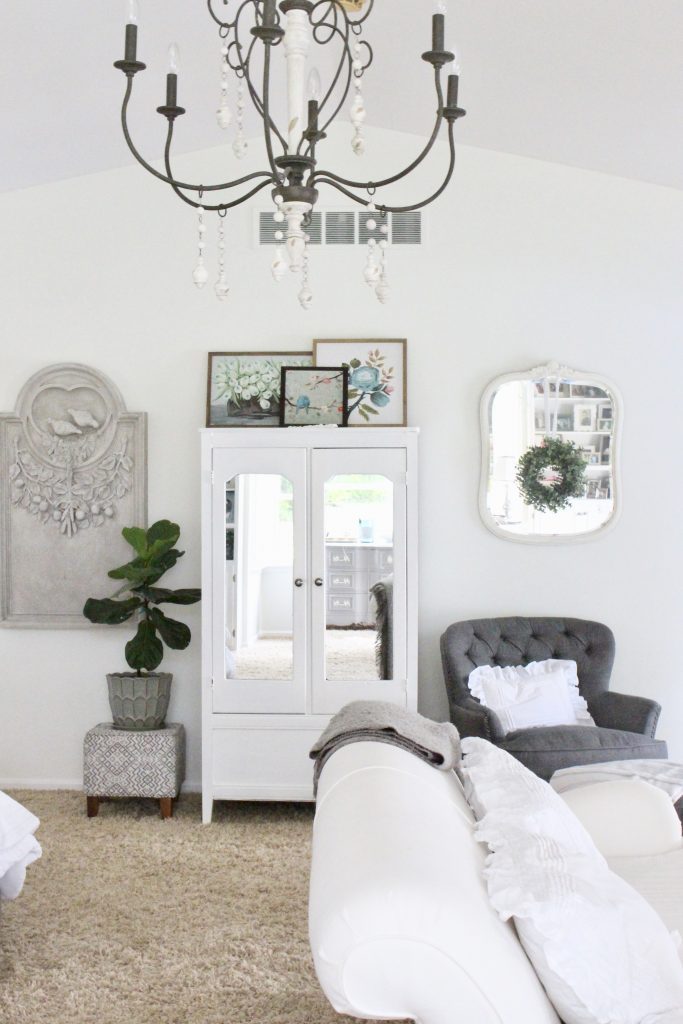 White Cottage Master Bedroom- gray- white- green- shabby chic bedroom- farmhouse decor- layered mirrors- painted gray furniture- DecoArt- Repose Gray- white bedding- white painted furniture- Armoire- fireplace in the bedroom- home design- large bedroom space- sitting area in the bedroom- bookshelves in a bedroom- fiddle leaf fig