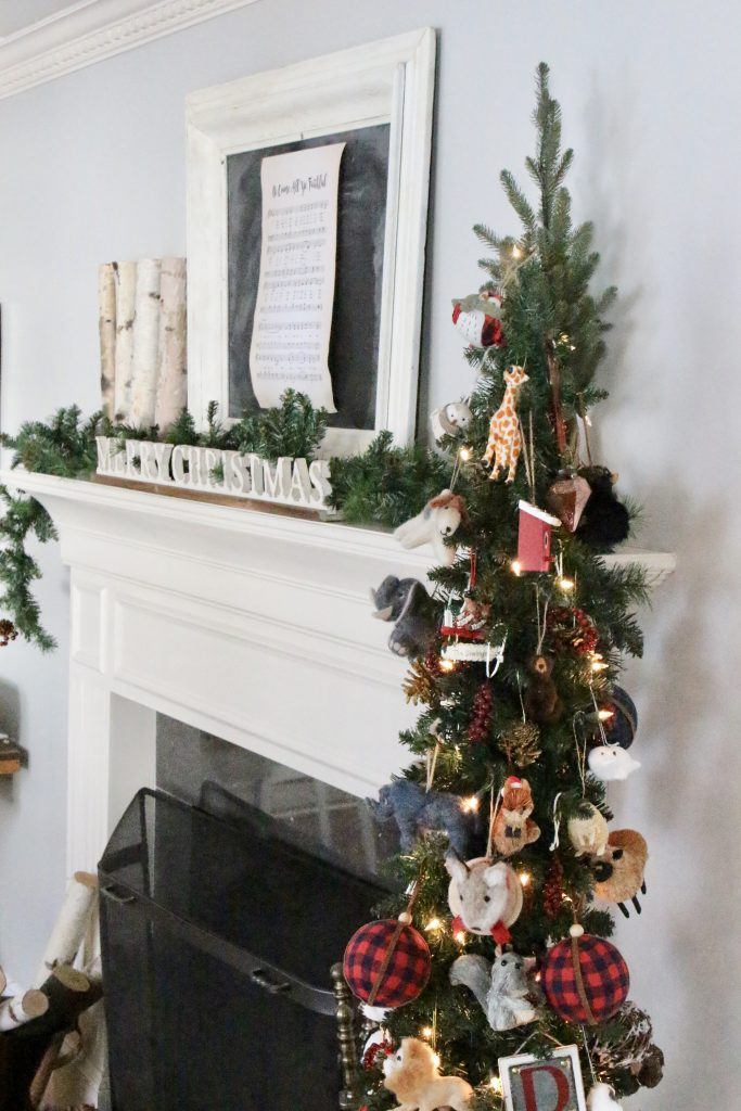 rustic- Christmas- mantel- mantle- animals- ornaments- slim tree in a basket- birch logs- copper pot
