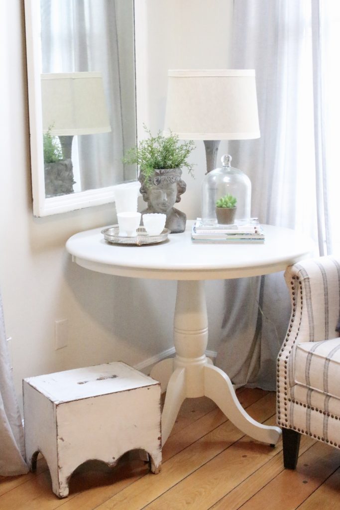 spring- decor- vignette- pedestal table- milk glass- faux greenery- decorating for spring- how to decorate a corner- white decor