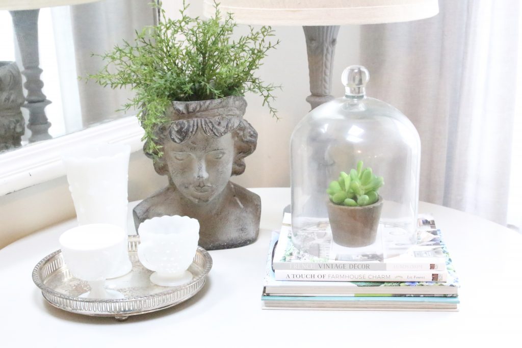 decorating books- spring- decor- vignette- pedestal table- milk glass- faux greenery- decorating for spring- how to decorate a corner- white decor