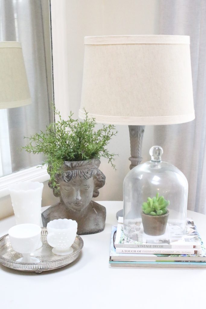 spring- decor- vignette- pedestal table- milk glass- faux greenery- decorating for spring- how to decorate a corner- white decor