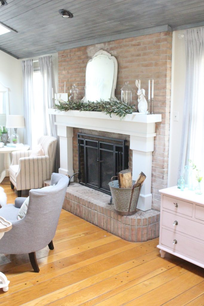An updated family room space with seasonal spring decor, spring- family room decor- gray washed ceiling- pink decor- gray decor- using pastels in decorating- large family room space