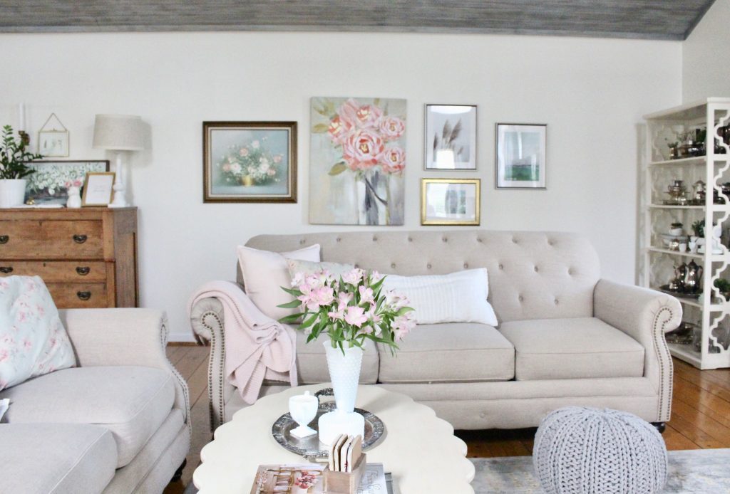 An updated family room space with seasonal spring decor, spring- family room decor- gray washed ceiling- pink decor- gray decor- using pastels in decorating- large family room space- silver collection- milk glass