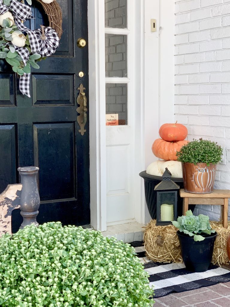 Fall Porch with Touches of Halloween, front porch decor, fall porch decor, pumpkins, decorating for Halloween, lanterns, porch decorating, fall, layered rugs, mums, porch bench, fall wreath