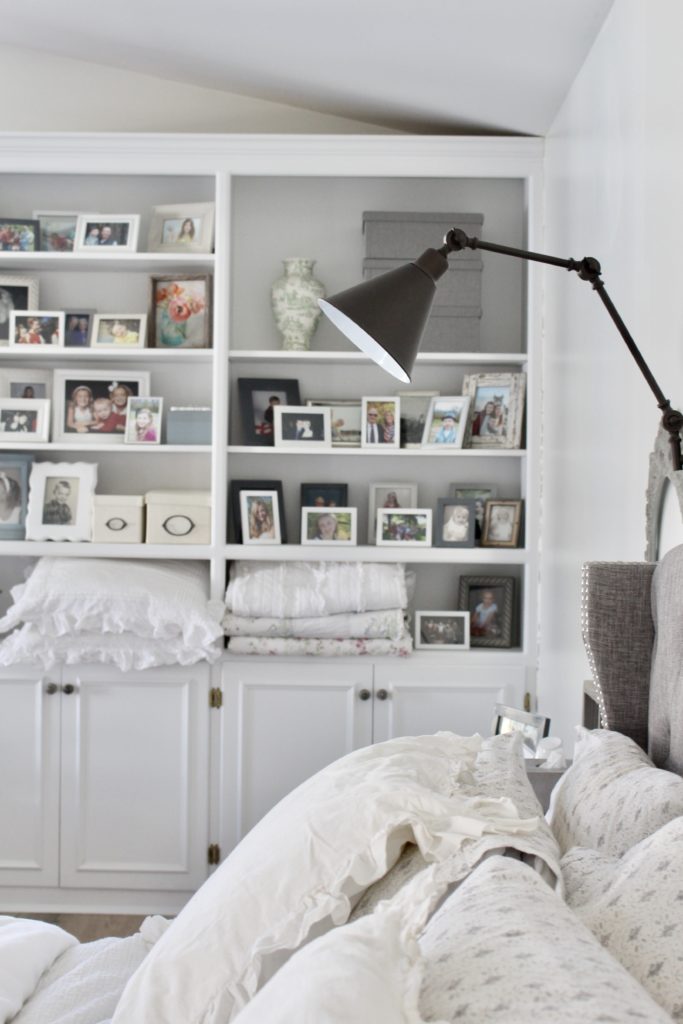 Cozy reading lamp over bed with bookshelves