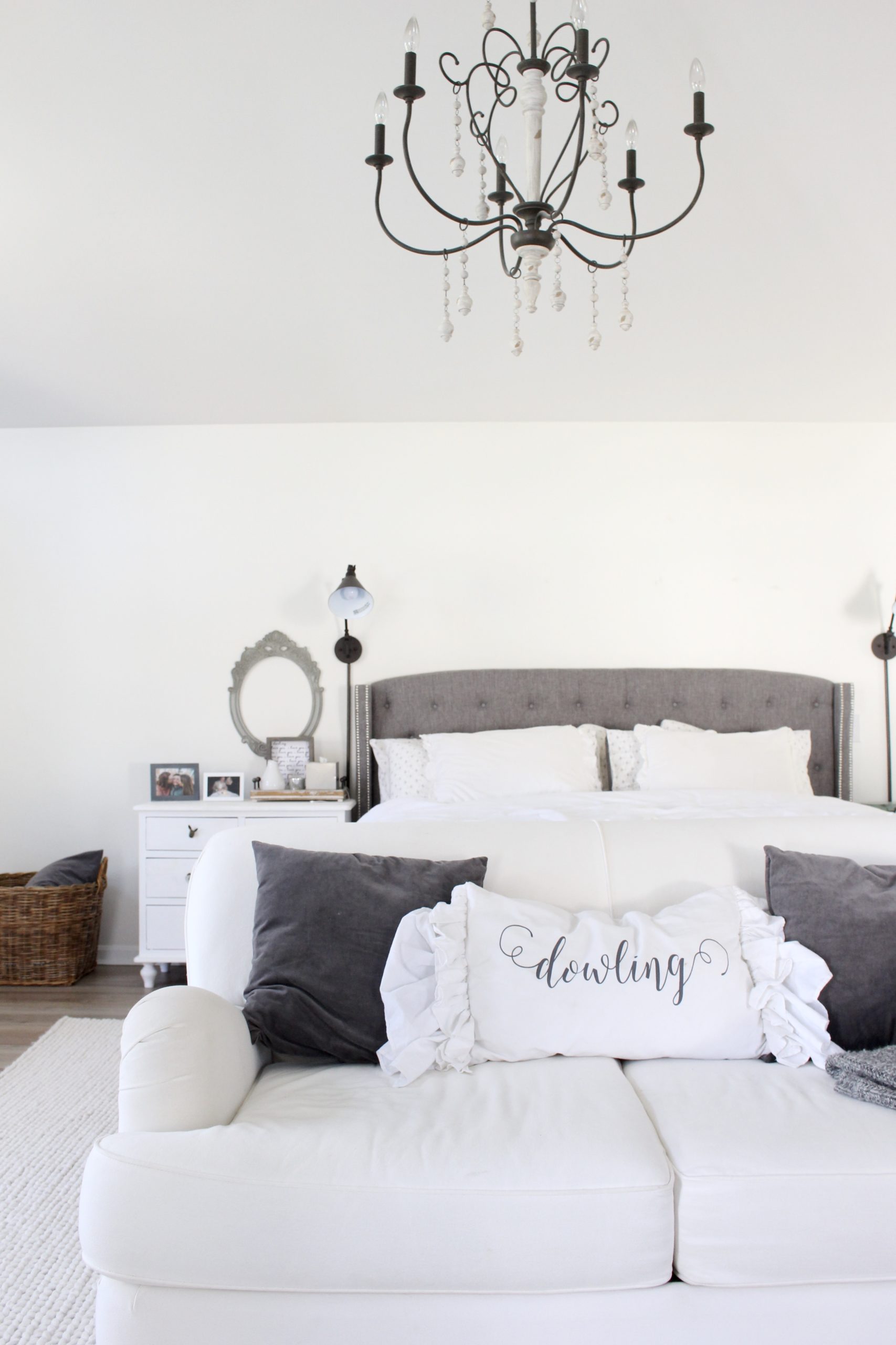 Cozy white master bedroom- An updated space with new flooring and a retiled fireplace