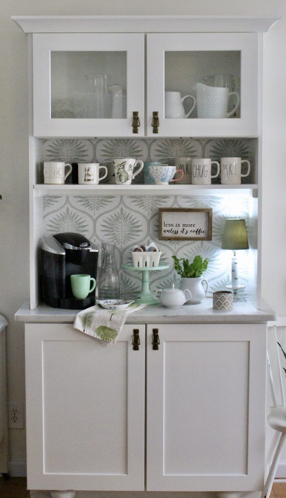 A thrifted coffee station cabinet with removable wallpaper on it's background