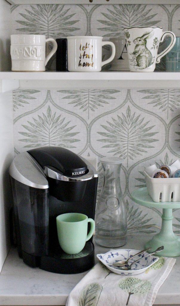 Green leaf wallpaper at a coffee station