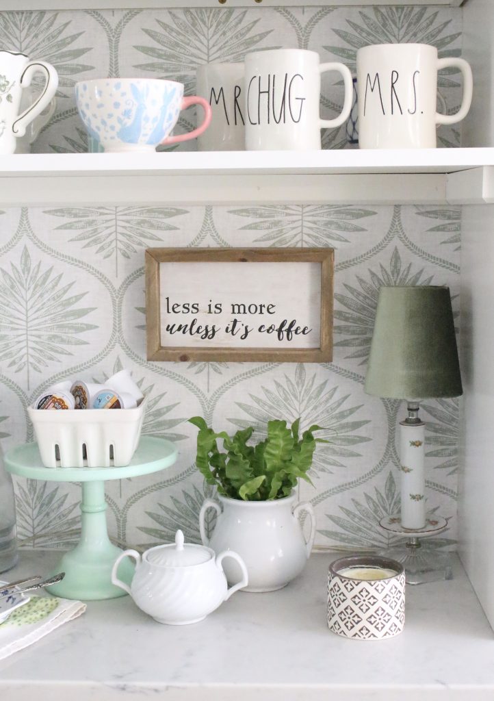 Rae Dunn coffee mugs against fun wallpaper