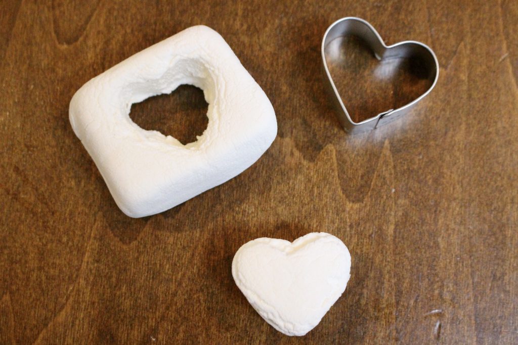 A jumbo marshmallow with a heart shape cut out using a small metal heart cookie cutter
