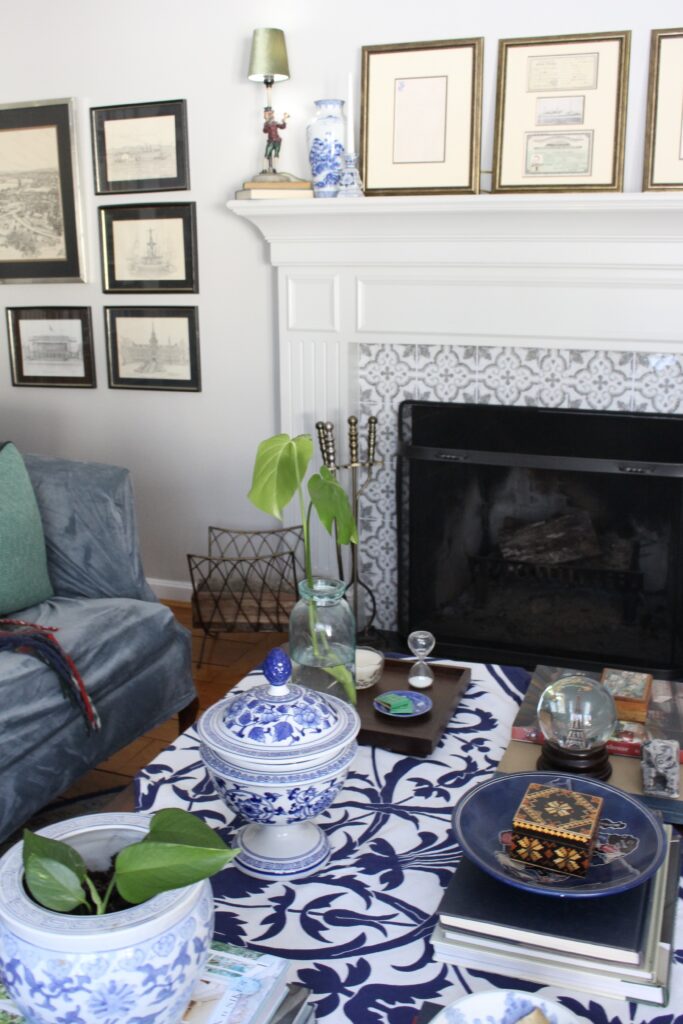 Colourful home library fireplace with smart tile surround, gallery wall, and blue and white styled coffee table