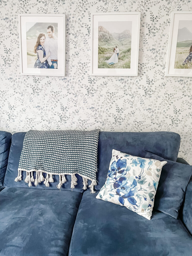 Borastapeter wallpaper with a blue sofa and watercolour cushion covers from Shein