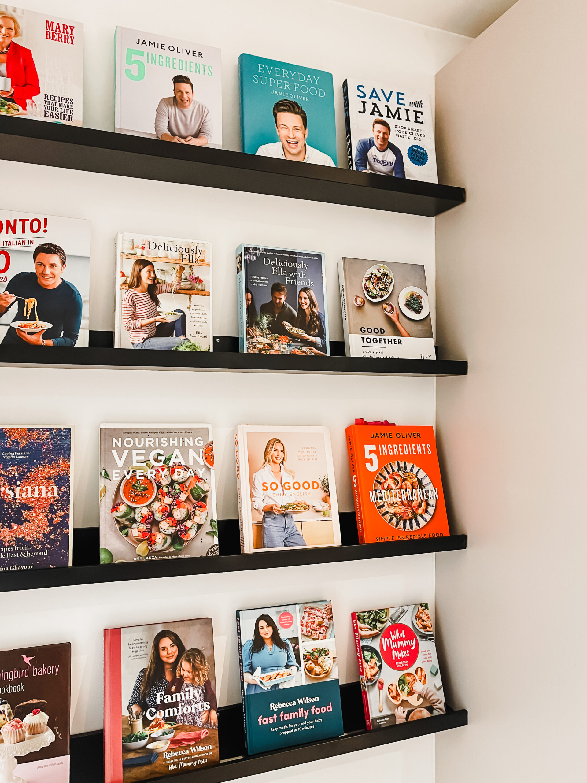 Close-up of cookbooks displayed on customized Ikea shelves