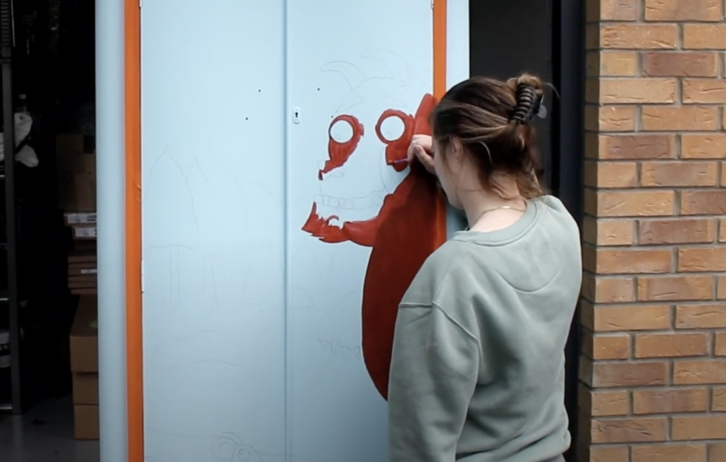 painting the Gruffalo onto the wardrobe using valspar sample pots
