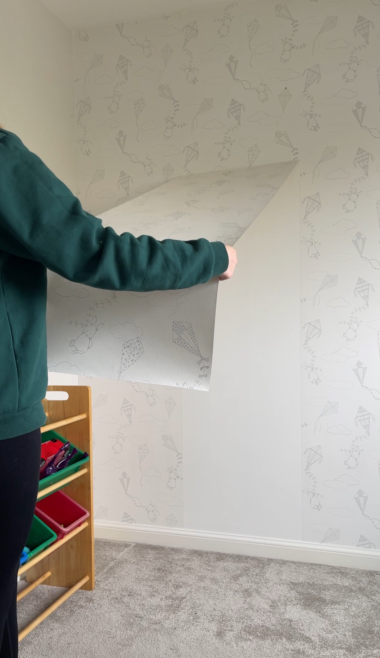 Peeling nursery wallpaper off the wall in a new-build home