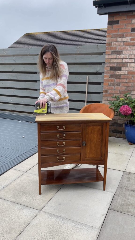 Vintage music cabinet covered in thick varnish before restoration.