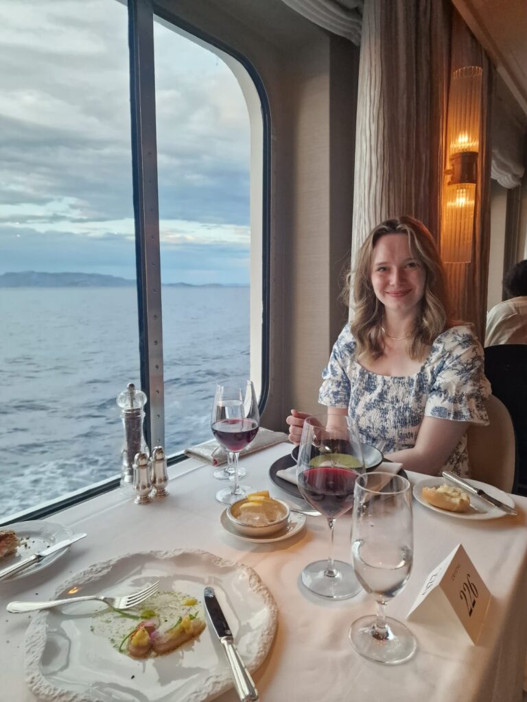 Enjoying dinner on a cruise ship wearing a casual summer dress