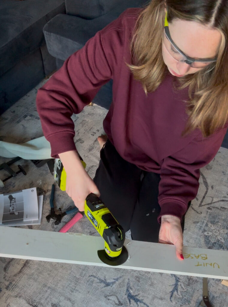 Using a Ryobi multitool to remove nails from a skirting board