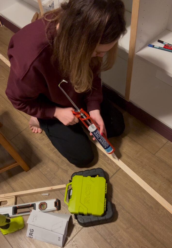 applying glue to furniture trim