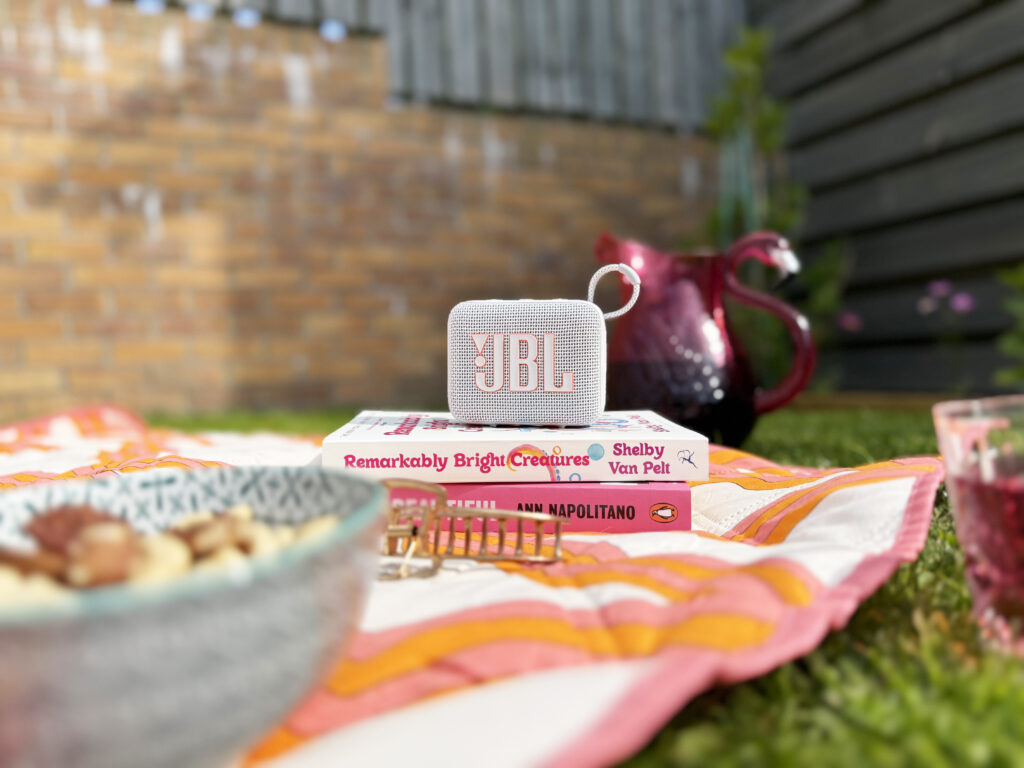 JBL GO 4 Compact Portable Speaker playing music in the garden