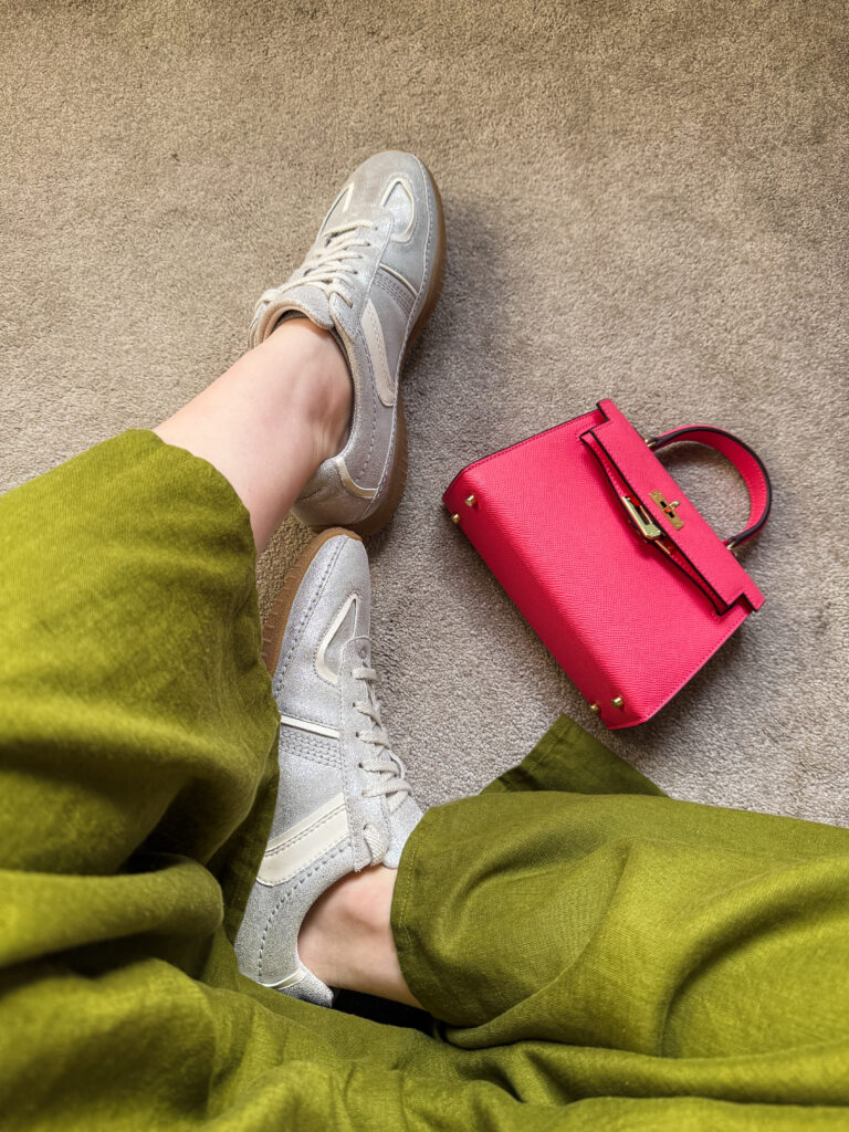 silver metallic shoes with a green dress and a pink mini kelly handbag