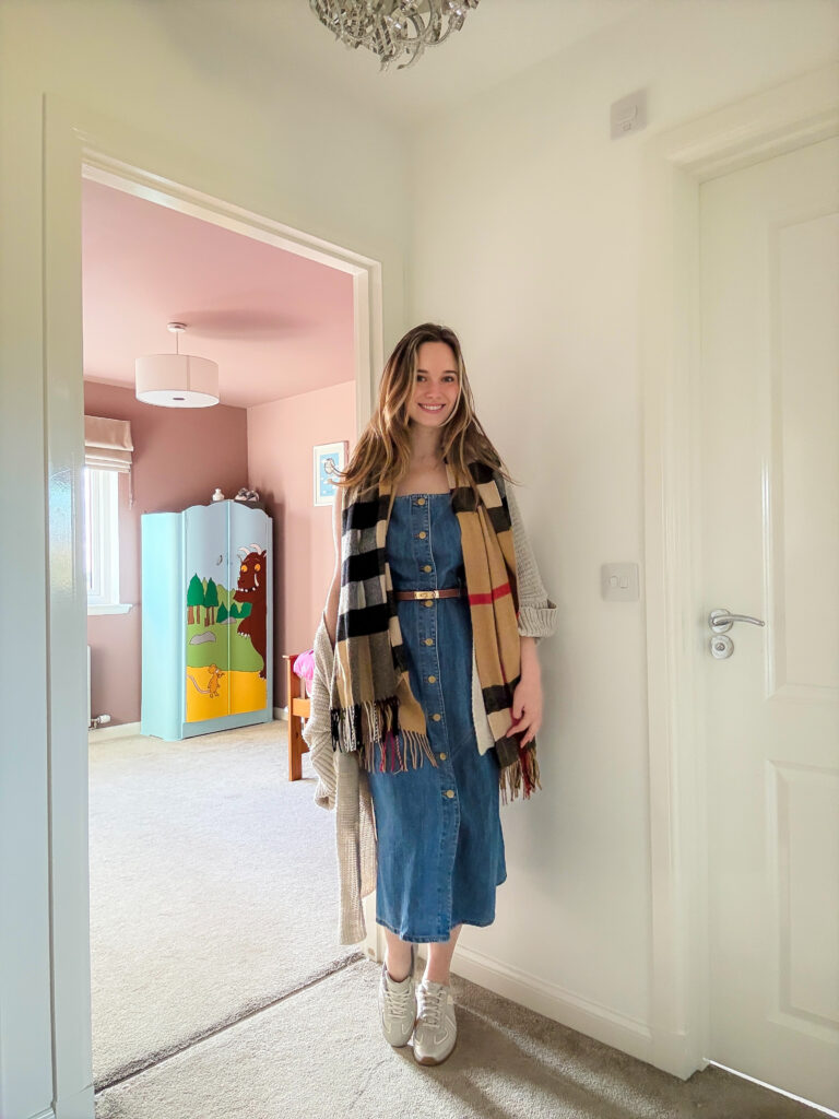Everyday autumn outfit with a button-down denim dress and white trainers, finished with a cosy knit scarf.
