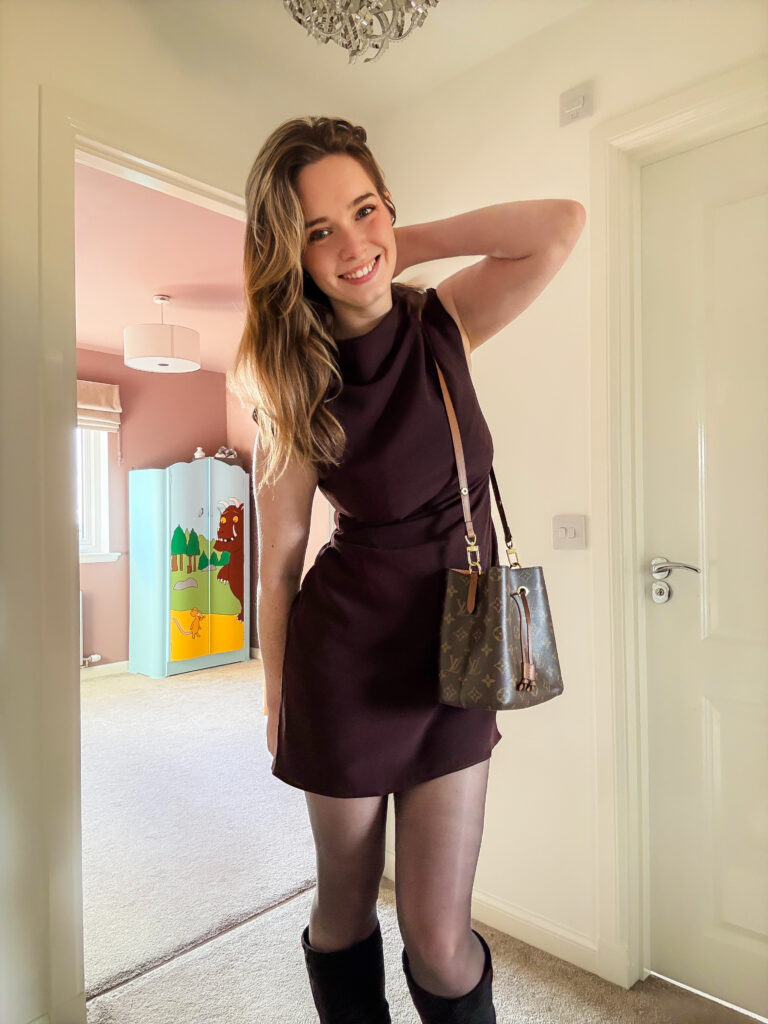 Stylish brown dress styled with boots, a chic option for cool autumn evenings.