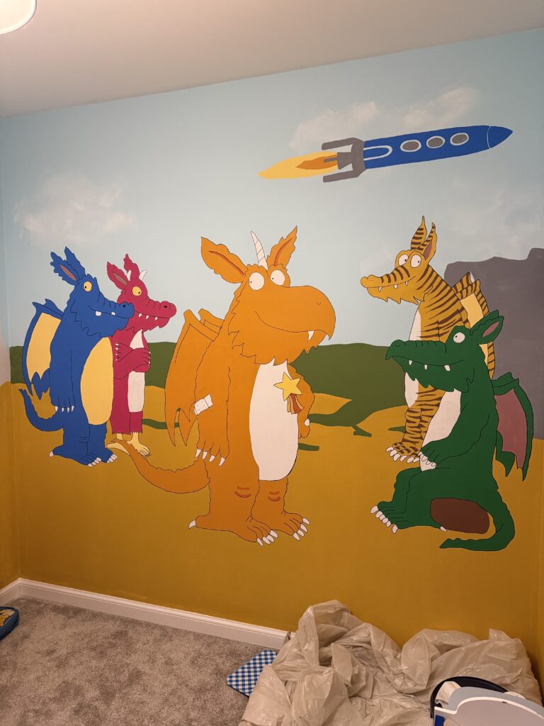 Full lineup of Zog and dragon characters hand-painted on a wall in a child’s bedroom, unfinished lower edge.