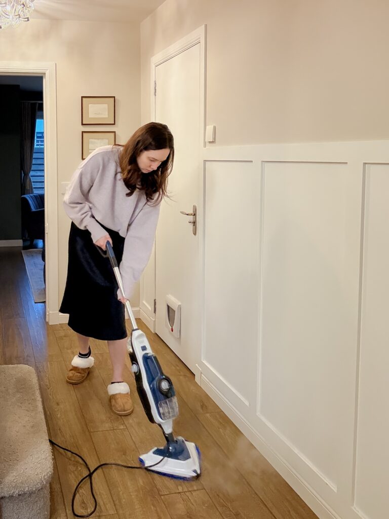 Steam mopping wooden hallway floors with the Vax Steam Fresh Total Home