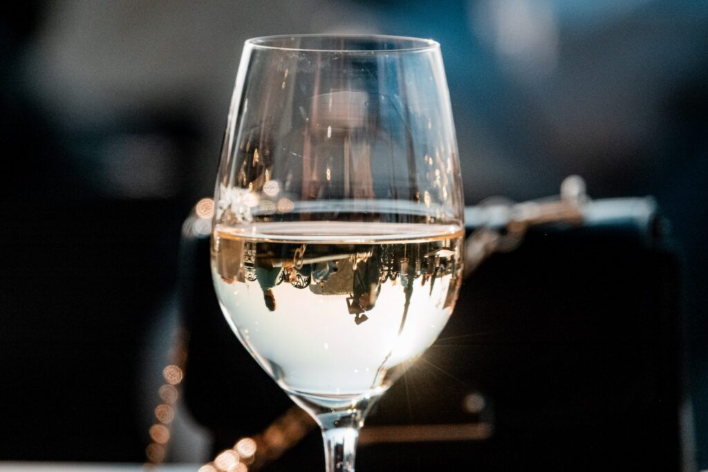 Glass of white wine at Waves restaurant, Grand Hotel Amrath Kurhaus, with soft bokeh background