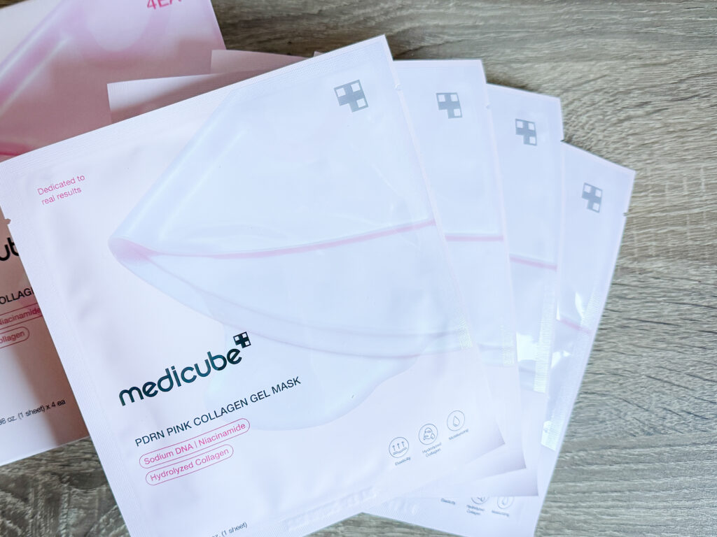 Four Medicube PDRN Pink Collagen Gel Mask individual packets fanned out, showing Sodium DNA, Niacinamide and Hydrolyzed Collagen on the packaging