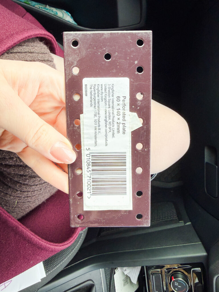 An Abru steel perforated plate used to join two decking boards end-to-end inside the raised planter