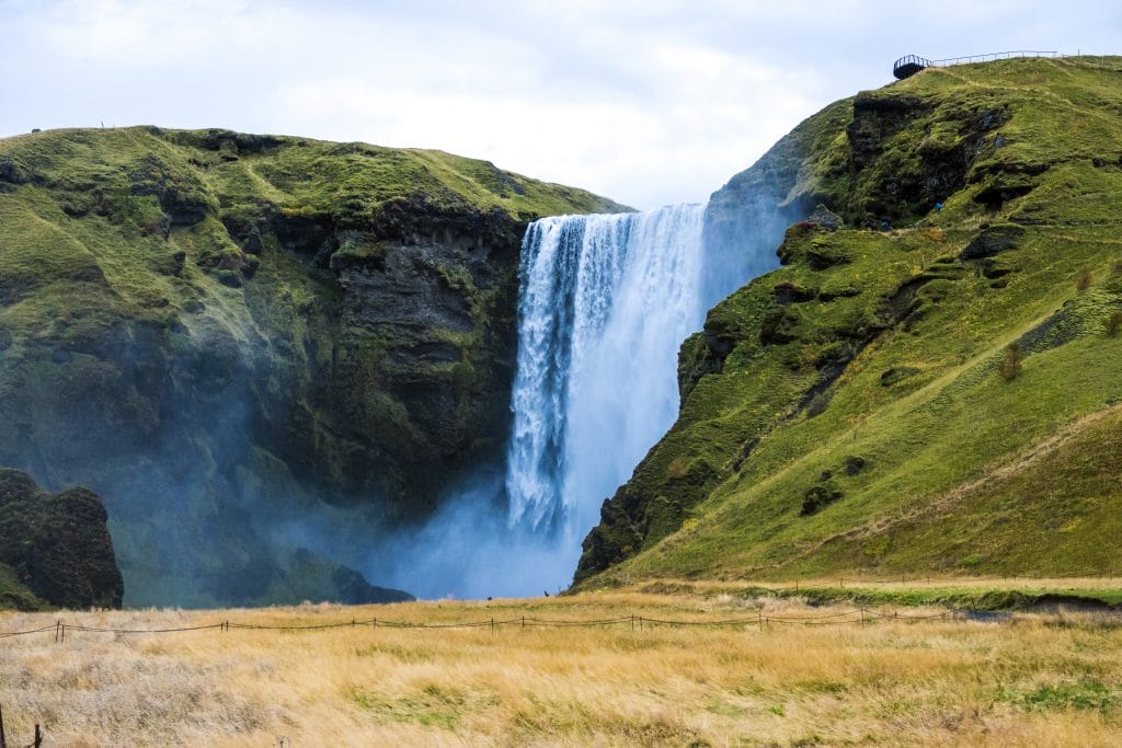 Skógafoss waterfall thundering down a mossy cliff face on Iceland's south coast