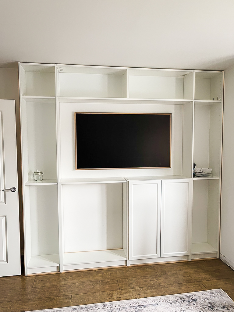 horizontal bridge shelf made from billy bookcase positioned above tv opening