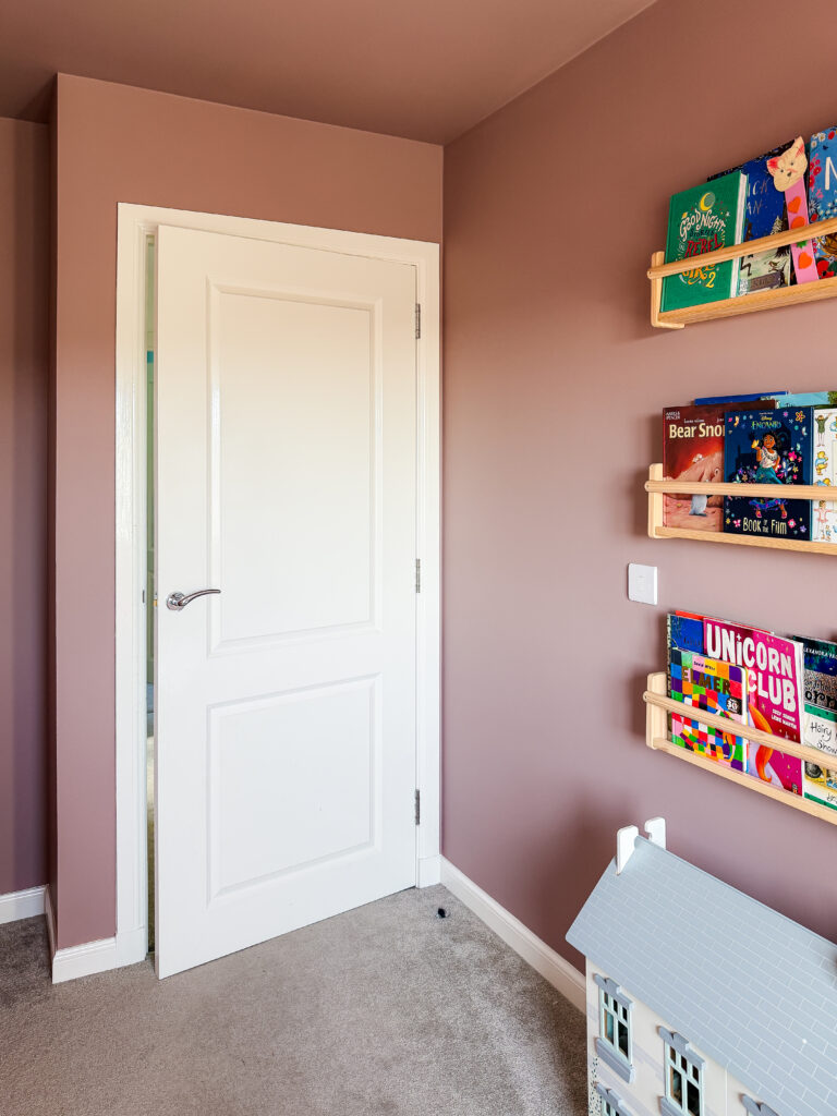 white panelled door against farrow and ball sulking room pink walls showing how the colour wraps around a children's bedroom